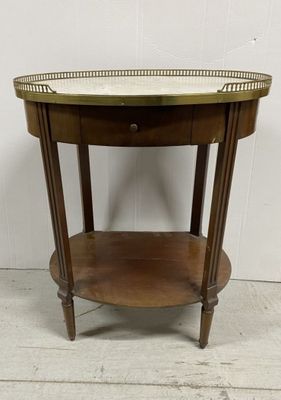 a round wooden table with a marble top on a white floor