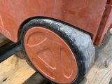 a red toy truck sitting on top of a wooden pallet