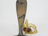 a vase that is sitting on a table next to a rope