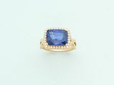 an image of a blue sapphire and diamond ring on a white surface