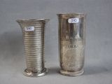 two silver vases sitting next to each other on a table