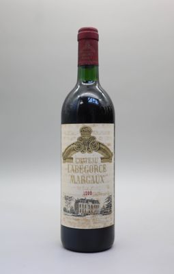 une bouteille de vin rouge posée sur une table blanche