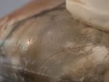 a close up of a glass vase with a toothbrush on it