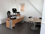 a room with a desk, chairs, and a chair in it