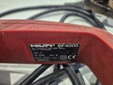 a close up of a corded sander on a table
