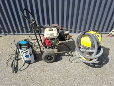 a machine that is sitting on the ground next to a hose