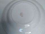 a white plate with a brown spot on it