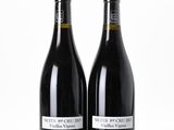 two bottles of wine sitting next to each other on top of a table