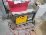 a red box sitting on top of a cart in a garage
