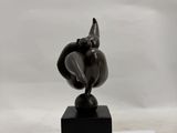 statue of an elephant on a black base on a white surface