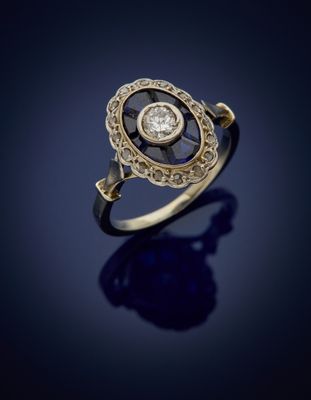a gold and diamond ring, by person