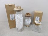 a glass jar with a wooden lid and a paper towel in it