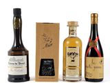 three bottles of wine and a box of liquor on a white surface
