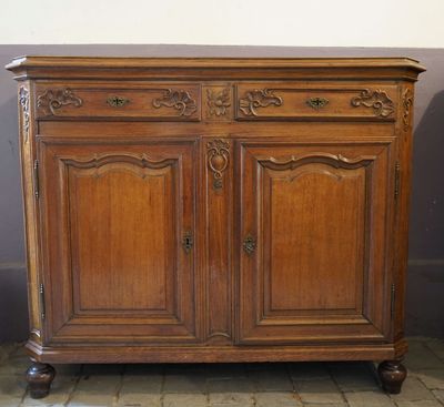 an old wooden cabinet sitting on top of a tiled floor