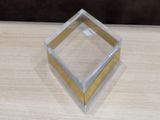 a clear box with a gold edge on a wooden table