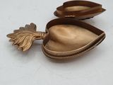 a gold spoon and a gold spoon with a leaf on it