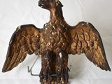 a statue of an eagle that is sitting on a hook