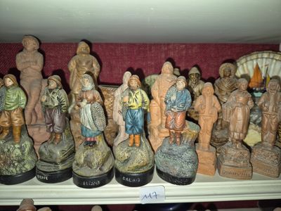 many figurines that are on a shelf together