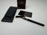 a black pen and a black wallet on a white table