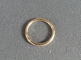 a close up of a gold ring on a gray surface
