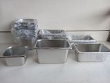 several pans of food are lined up on a counter