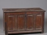 an old wooden chest sitting on top of a gray floor