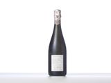 a bottle of wine sitting on top of a white table