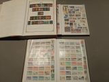 two open books with stamps on them sitting on a table