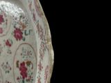 a white plate with pink flowers on it on a table
