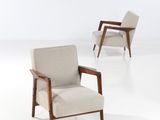 three chairs in a room with white walls and a white floor