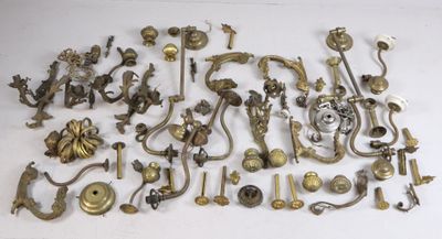 a lot of antique brass door handles and knobs