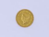 a close up of a gold coin on a white surface