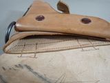 a leather bag with a leather handle on top of it