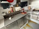 a dirty kitchen with a lot of counter space and a lot of counter space