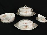 four pieces of china sitting on a black table