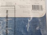 a bag of blue jeans sitting on top of a white table