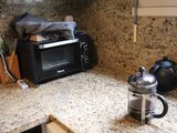 a microwave and a kettle on the counter in the kitchen