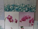 four paintings of flowers on the wall of a room