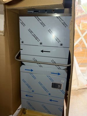 a stack of refrigerators in a cardboard box in a room