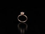 a close up of a diamond ring on a black surface