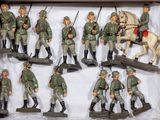 many figurines of men in military uniforms in a box