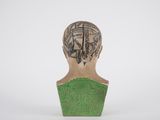 a close up of a sculpture of a person with tattoos on their head