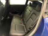 the back seats of a blue car are empty in the car