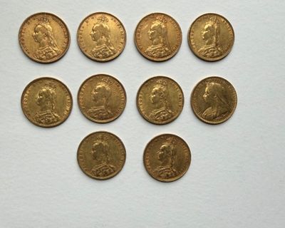 six different types of gold coins on a white surface