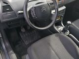 the interior of a small car with a steering wheel and dashboard