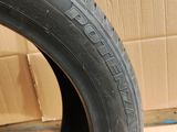a close up of a tire on a cardboard box with a cardboard box in the background