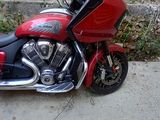 a red and black motorcycle parked on the side of the street