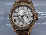 La montre est en or, avec un cadran blanc et une lunette sertie de diamants, sertie de diamants, sertie de diamants, sertie de diamants, sertie de diamants, sertie de diamants, sertie de diamants.