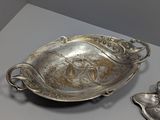 a silver plate that is sitting on a table