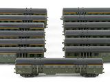 several model trains are lined up in rows on a white surface